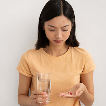 a girl taking a birth pill