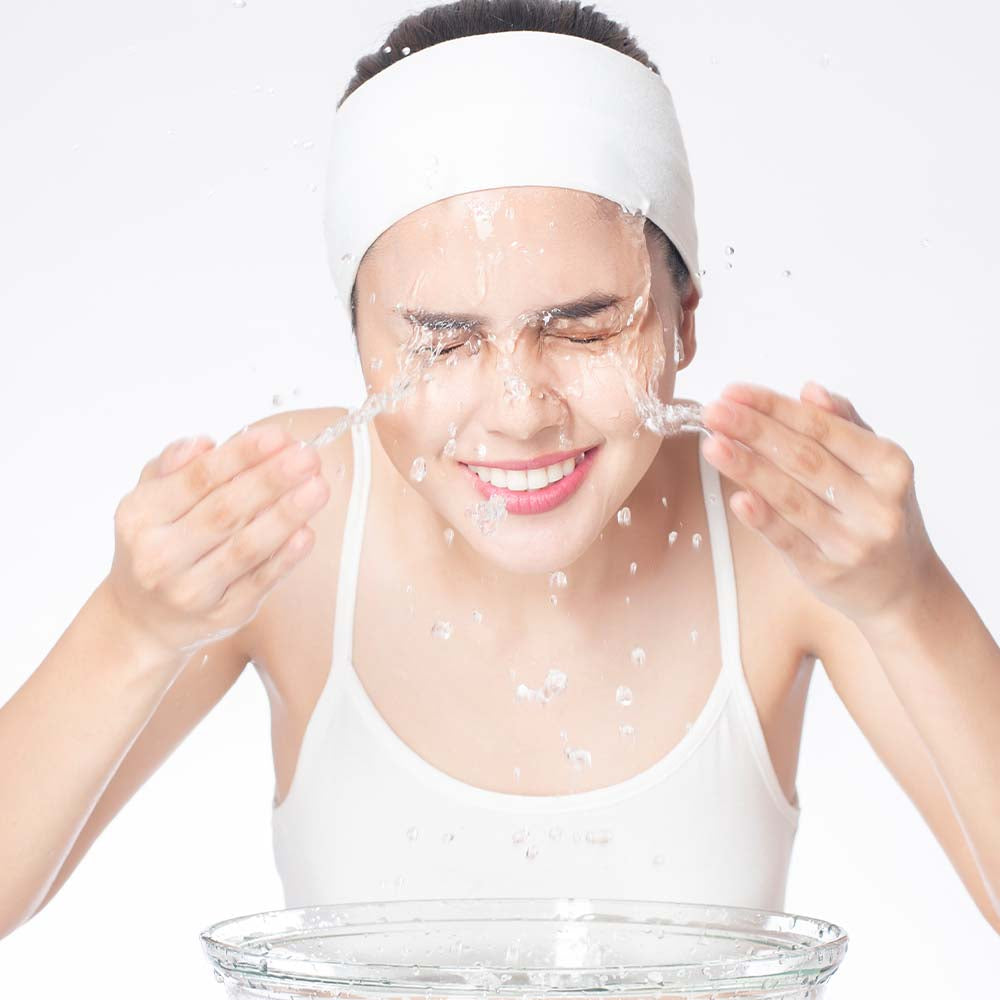 A girl washing her face with gentle non foaming face wash