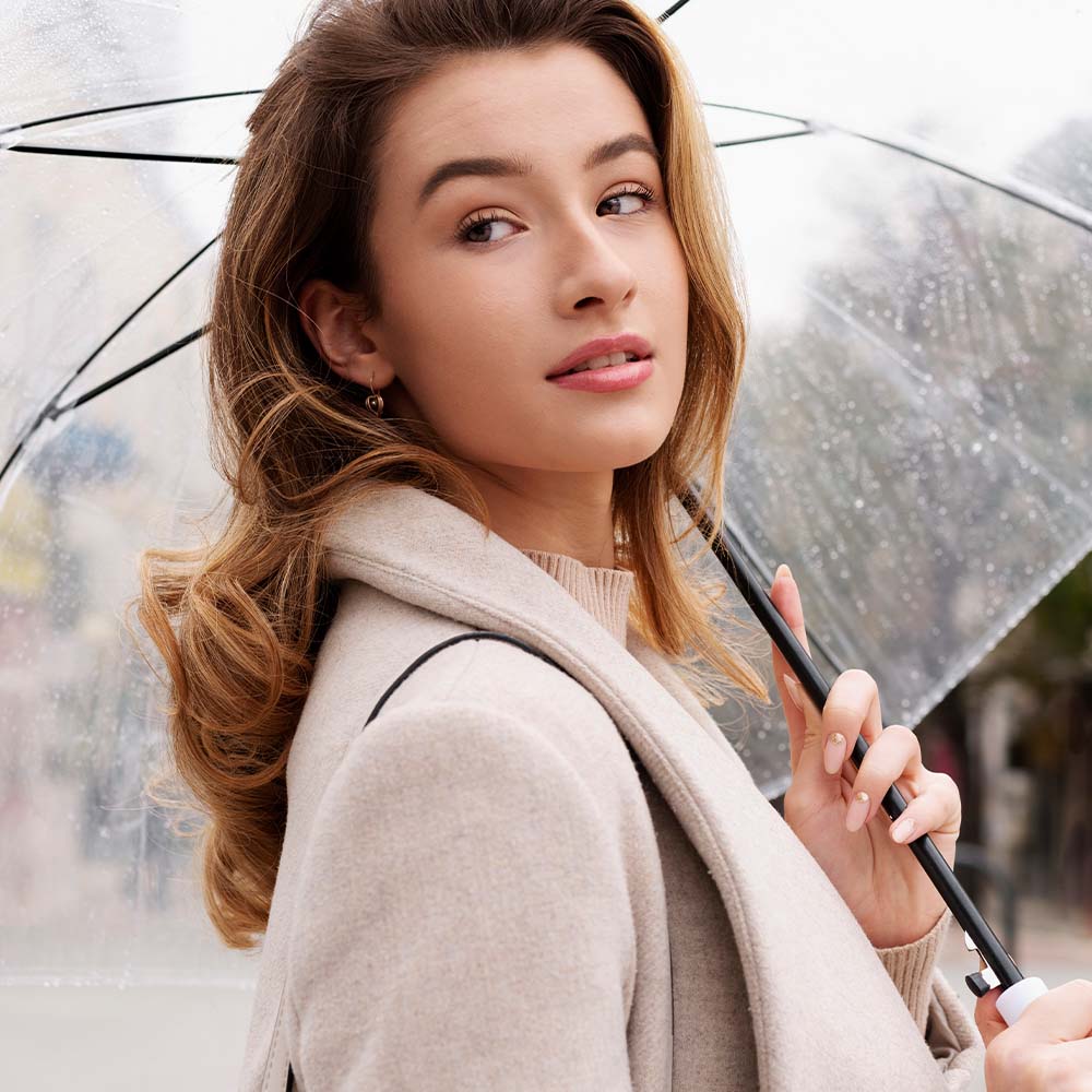 A girl having acne with umbrella in summer