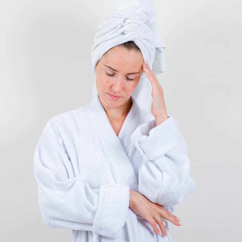 A stressed girl with her hands on her face, possibly due to acne, seeking relief and support.